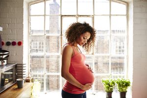 Pregnant woman holding her belly