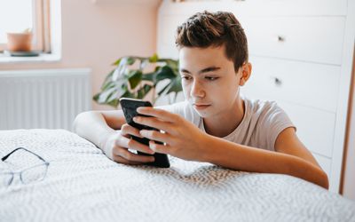 Teenage boy using cell phone