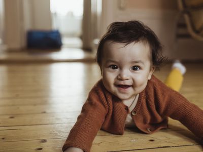 Smiling toddler lying on the ground