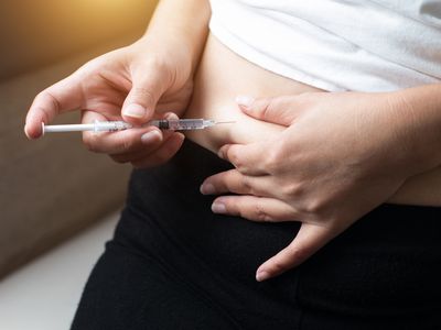 woman giving herself a subcutaneous injection