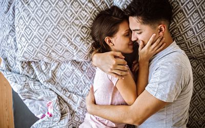 Couple in bed embracing