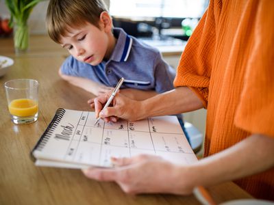 Mom and son filling out calendar