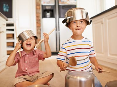 children with pots and pans on their heads