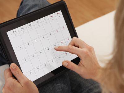 USA, Illinois, Metamora, Close-up of woman using calendar on digital tablet