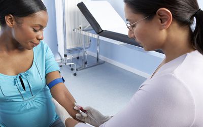 助产士正在孕妇的手臂上采集血液。助产士正在孕妇的手臂上采集血液样本。怀孕期间定期检查是必要的，这样可以监测婴儿的发育和母亲的健康。华体会体育官方人口血液检测可以提供母亲的营养信息，例如血糖水平、激素和抗体水平。