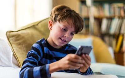 Boy playing with his phone