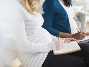 pregnant women taking notes in childbirth education class