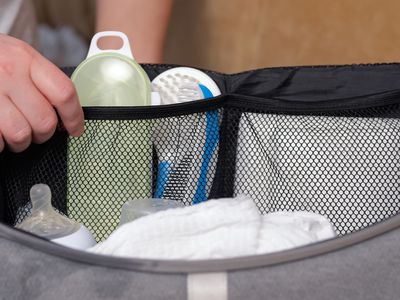 person packing a diaper bag