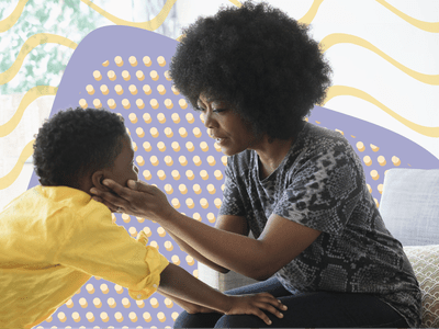 Mother holding son's face in the palm of her hands