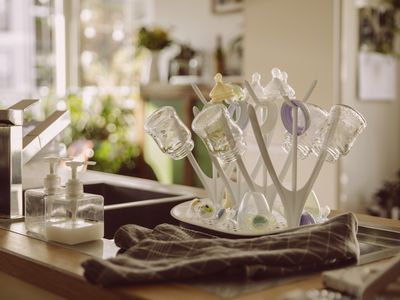 Milk bottles on drying rack in kitchen