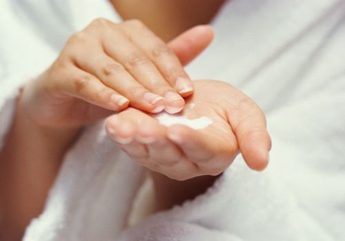 Woman holding moisturizer cream in her hand