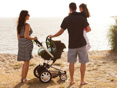 Family with Travel System Stroller on Beach