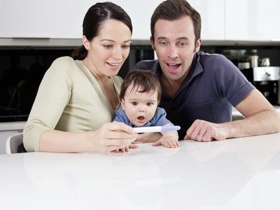 Surprised family looking at a pregnancy test