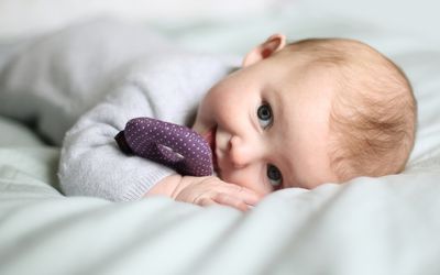 Baby girl on a blanket.