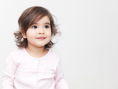 Girl smiling in long sleeve pink shirt