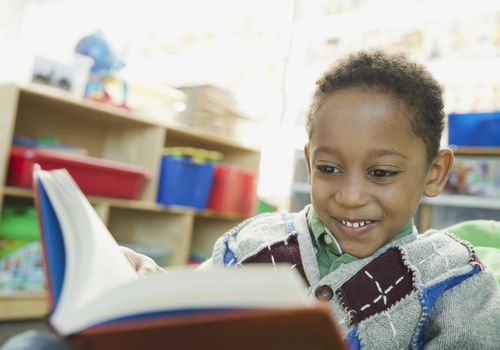 Boy reading in elementary school classroom