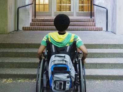 A disabled student in front of his school.