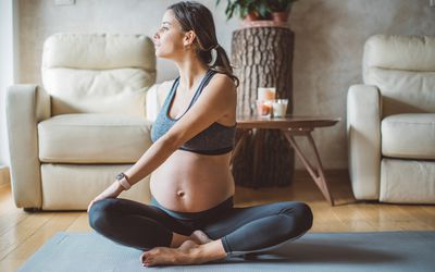 pregnant woman exercising at home