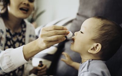 Child receives medication orally through a dropper