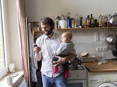 dad holding baby on left side