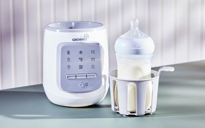 baby bottle with milk in a bottle warmer