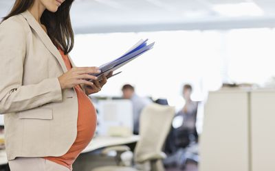 A pregnant woman in an office