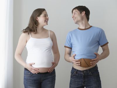 Mom and dad comparing bellies