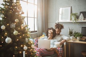 couple watching christmas movies on laptop