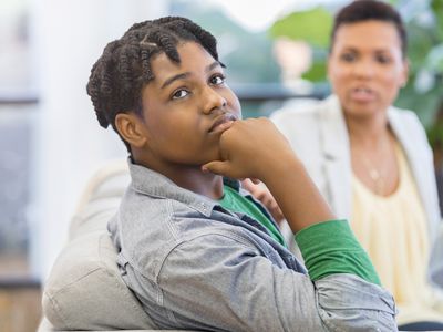 A boy looking away from his mother