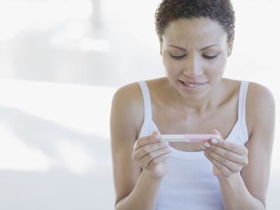 woman reading pregnancy test results