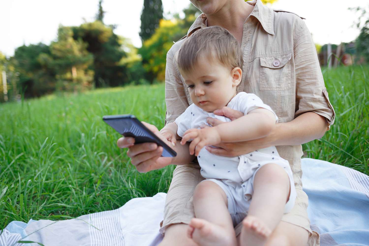 Mom showing her phone to her baby