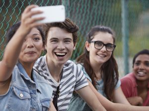 Friends making selfie outside school