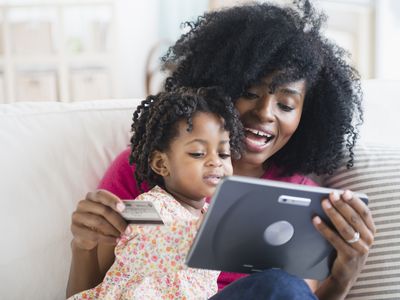 Mother and daughter shopping on tablet computer