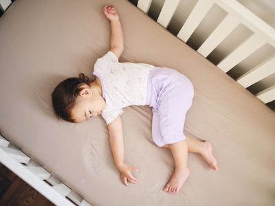 Toddler sleeping on mattress