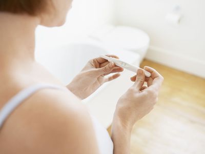 Woman Checking Pregnancy Test Kit