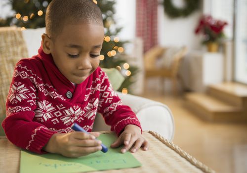 Young boy writing a letter to Santa