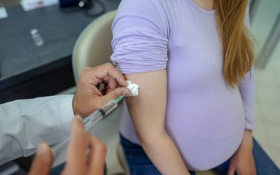 pregnant woman getting a shot