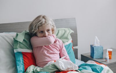 Child in bed with a cough