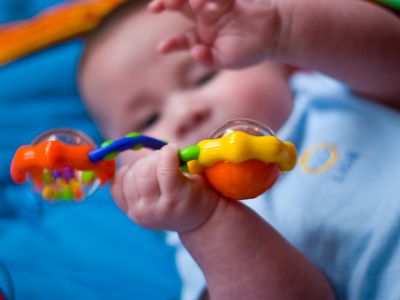 Baby playing with rattle