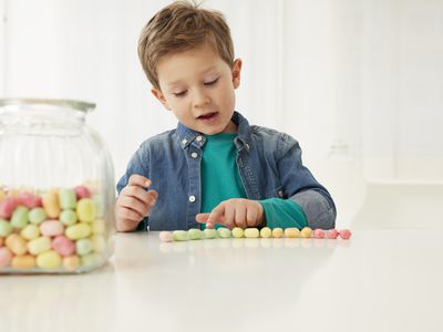 Child with a candy jar, counting the candies