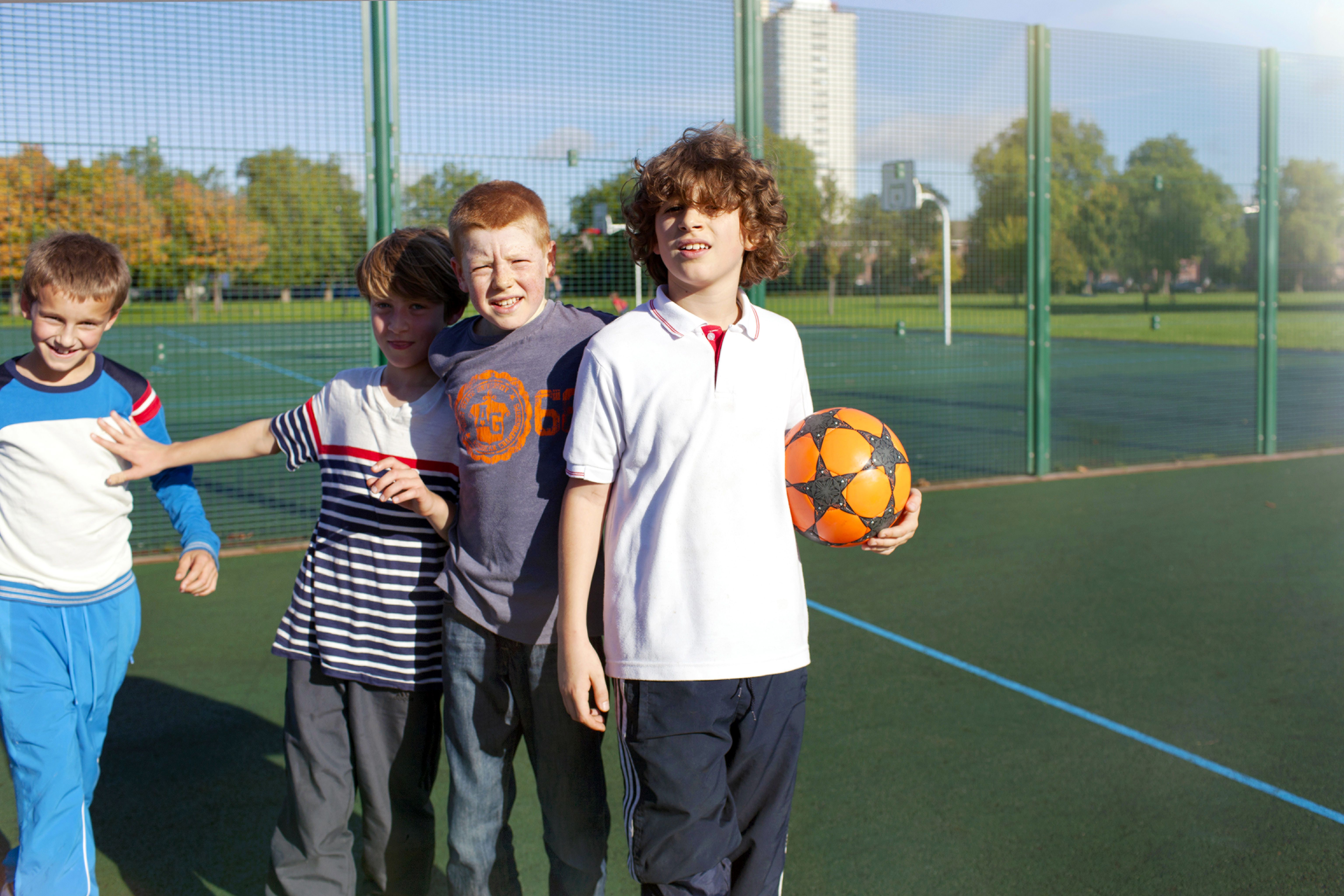 Boys playing outside on a court