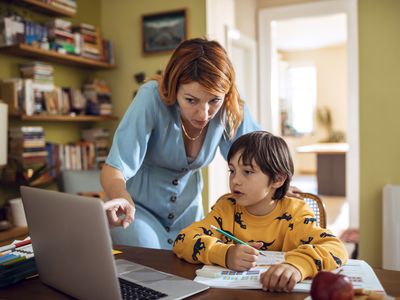 Mother helping son with homework