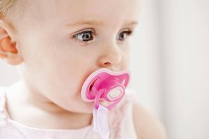 baby with pink pacifier