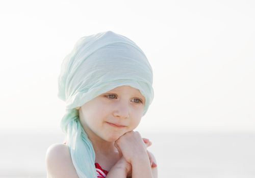 child in a head scarf