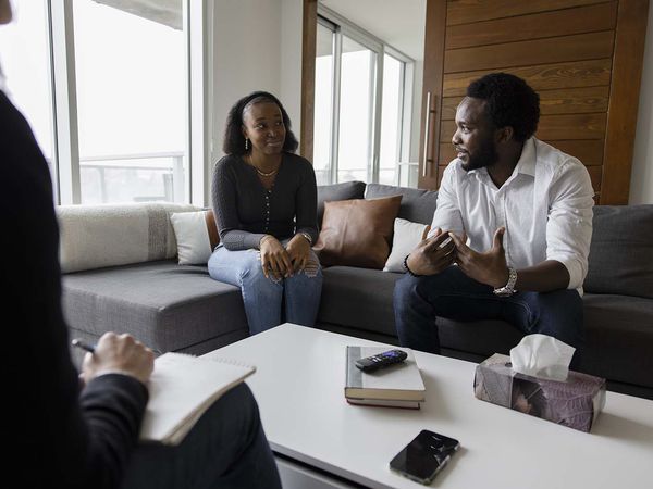 Couple on sofa talking during marriage counseling session