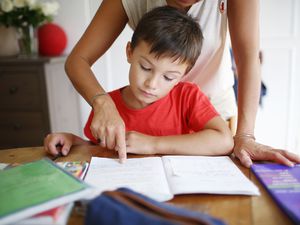 mom helping her son do his homework