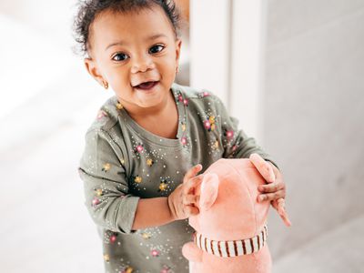 baby girl holding a toy