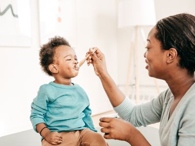 Mom feeding her baby yogurt