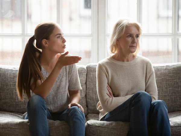 Younger woman and older woman arguing on the couch