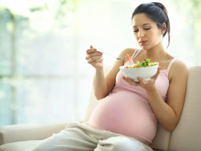 Pregnant woman eating tilapia
